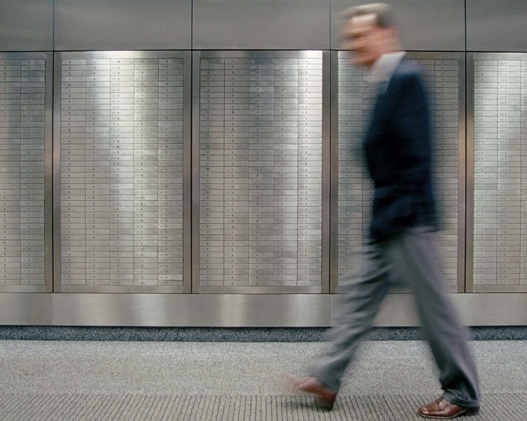 A businessman walks past lockers