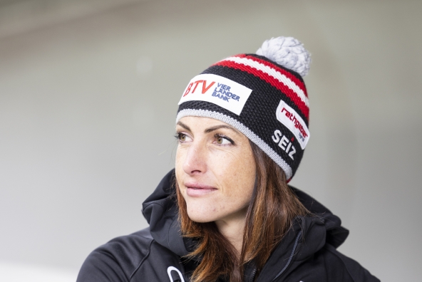 Skeletonfahrerin Janine Flock trägt eine Mütze auf schaut nach links.