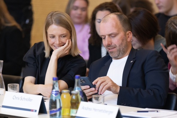 Zwei Personen sitzen an einem Tisch