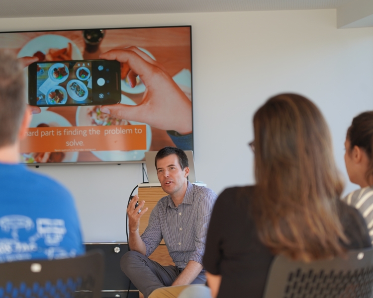 Ein Mann spricht mit einer Gruppe Personen