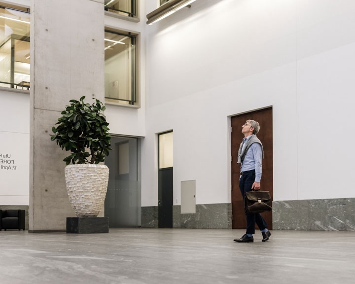 Man with is walking in a bank building.